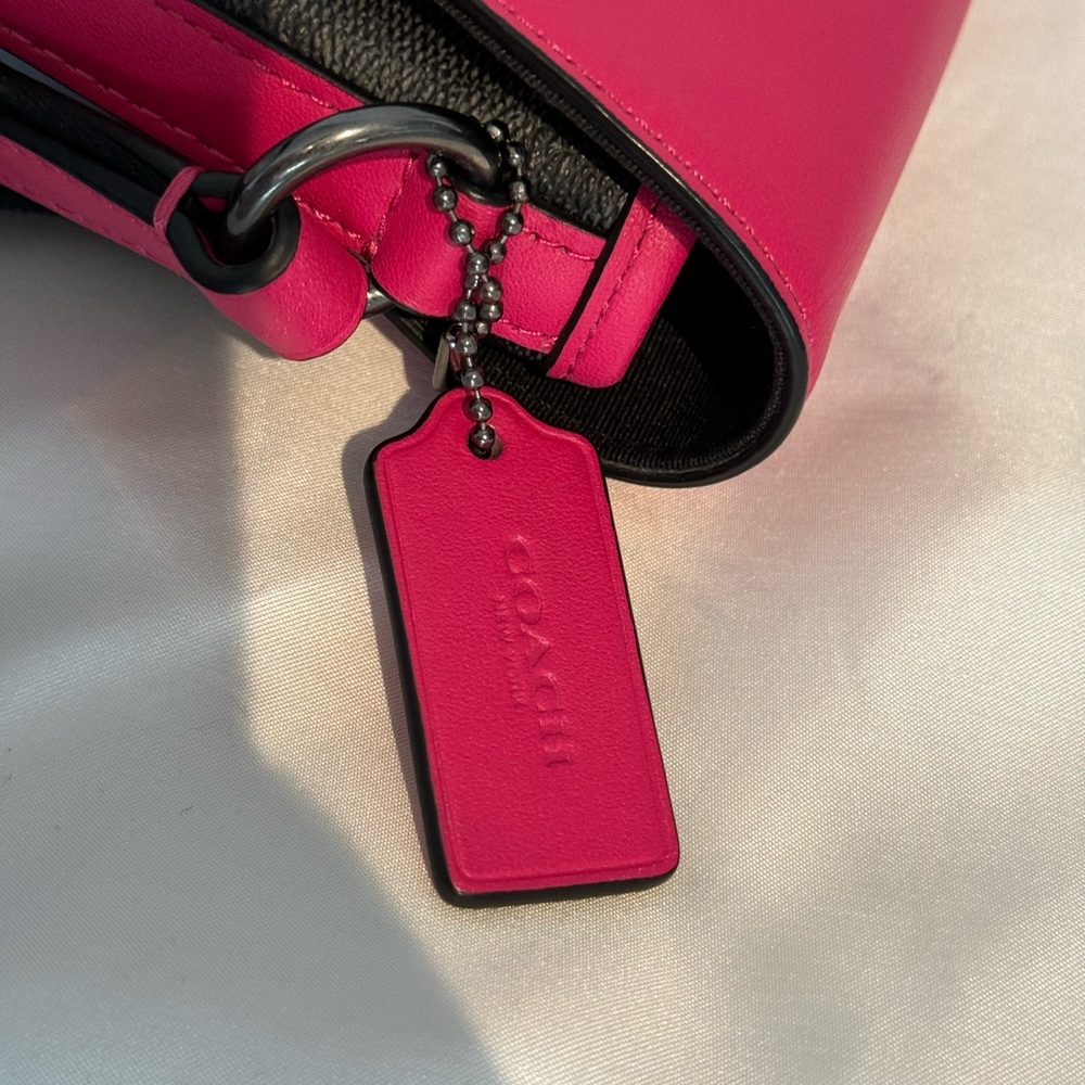 Pink and black coach purse
